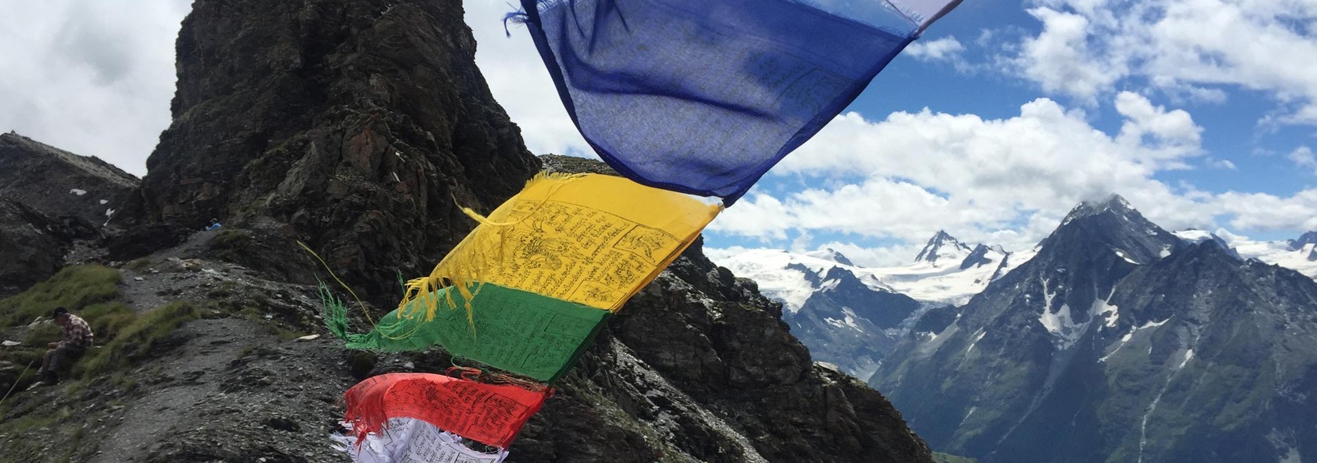 Classic Haute Route - Tibetan prayer flags blowing with the wind on the col de Torrent